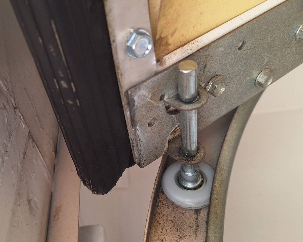 Off-track garage door with displaced roller inspected at a Las Vegas home