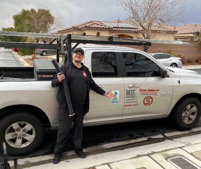 Garage door technician inspecting a broken spring at a Summerlin home
