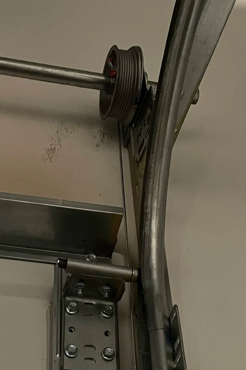 Garage door cable drum, torsion tube and curved track on a Las Vegas garage door